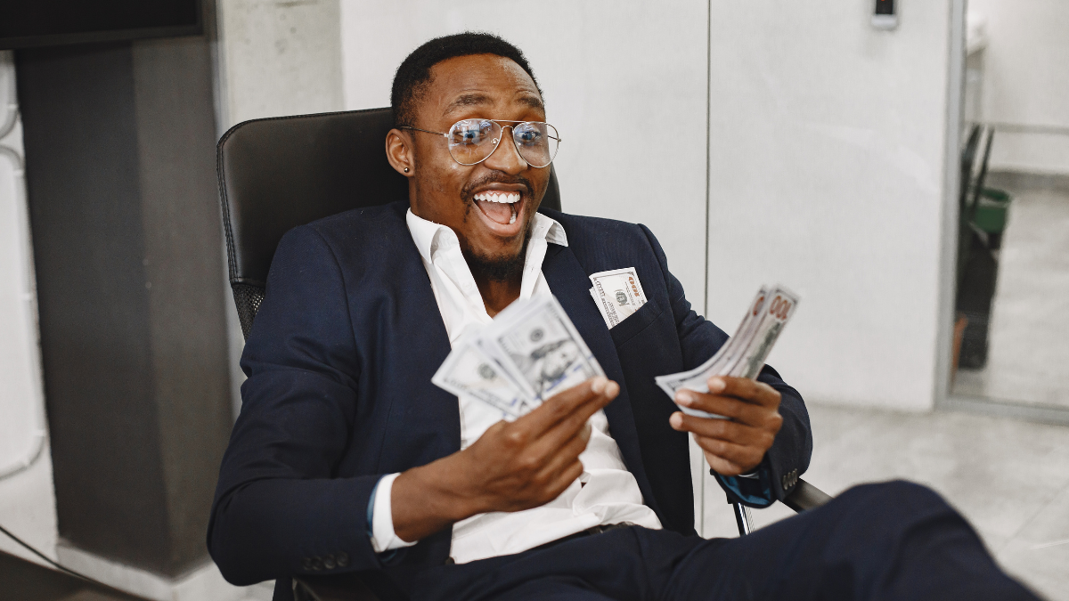 Person holding money representing September 2025 grants in New York for community projects and organizations.